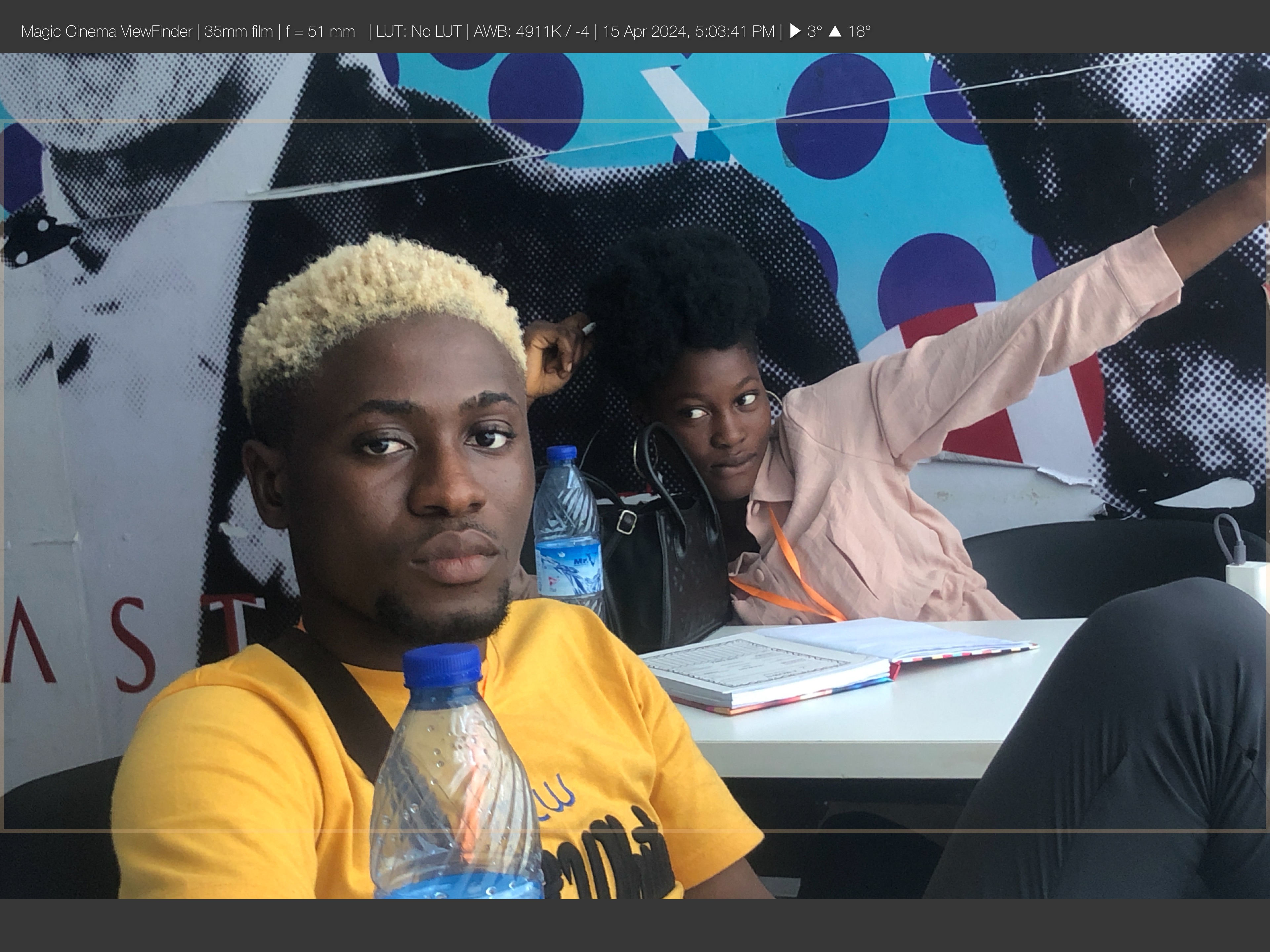 Cast members on set framed with a cinema viewfinder overlay