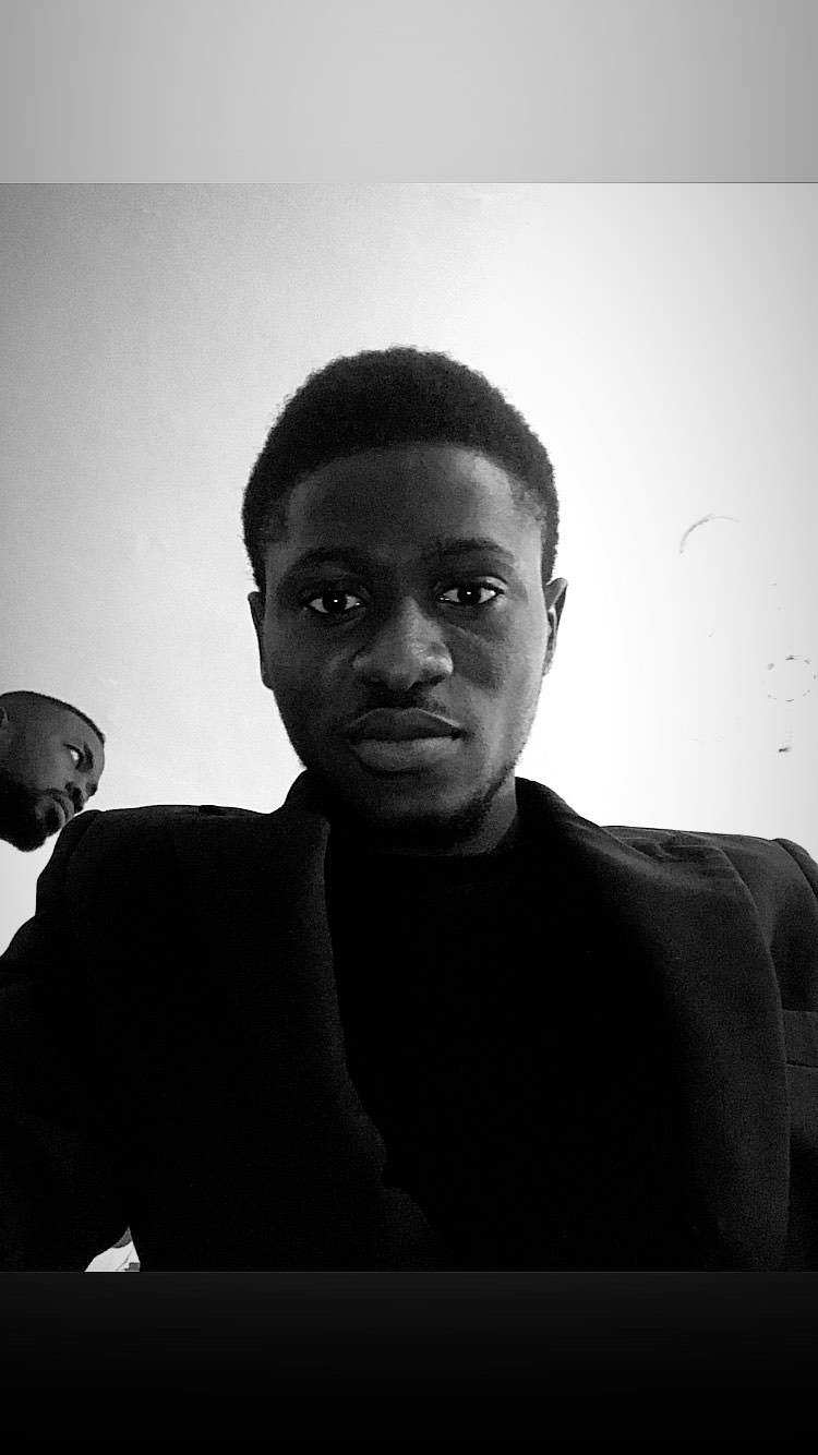 Black and white portrait of the founder in a blazer