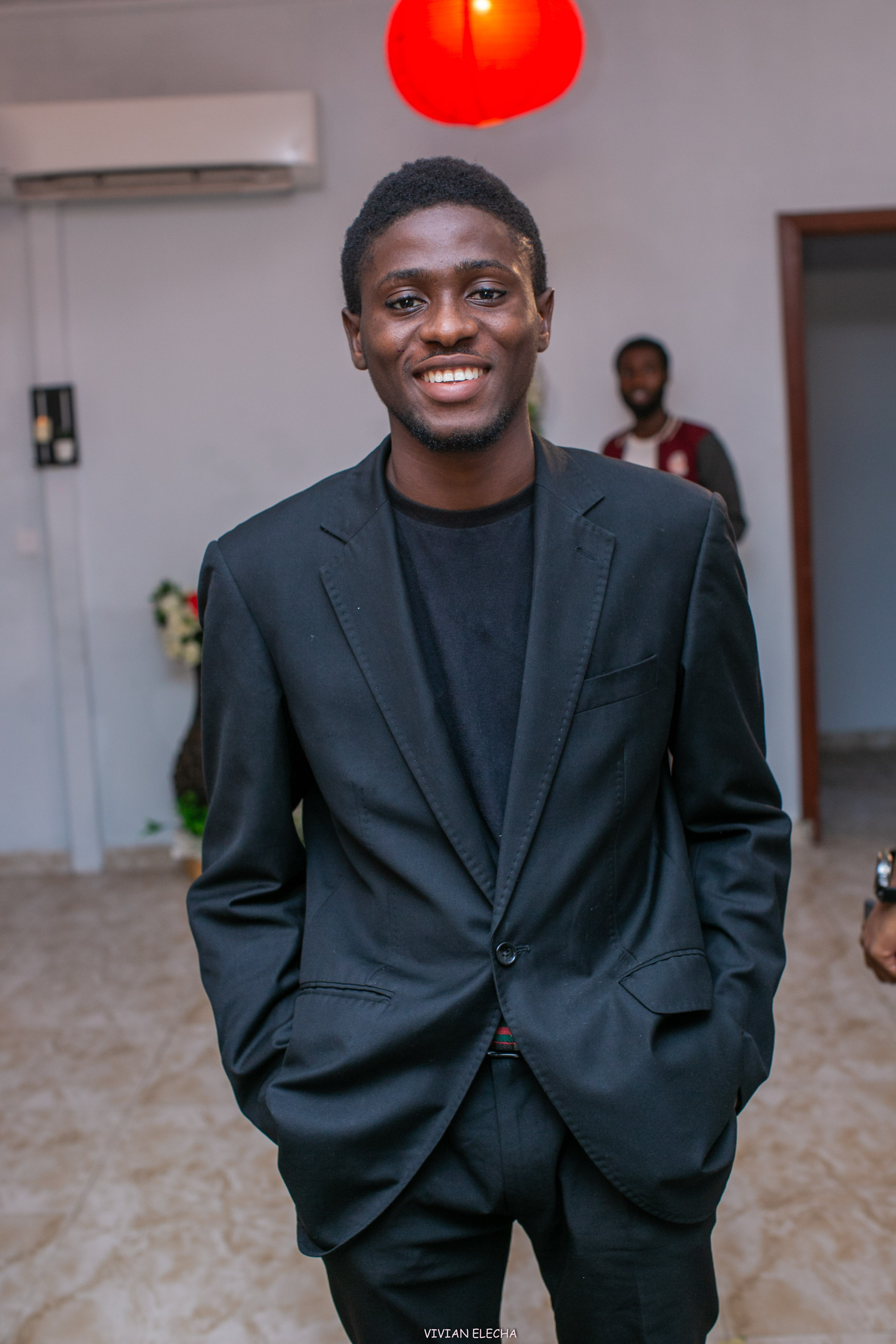 Portrait of the founder in a black suit at an event