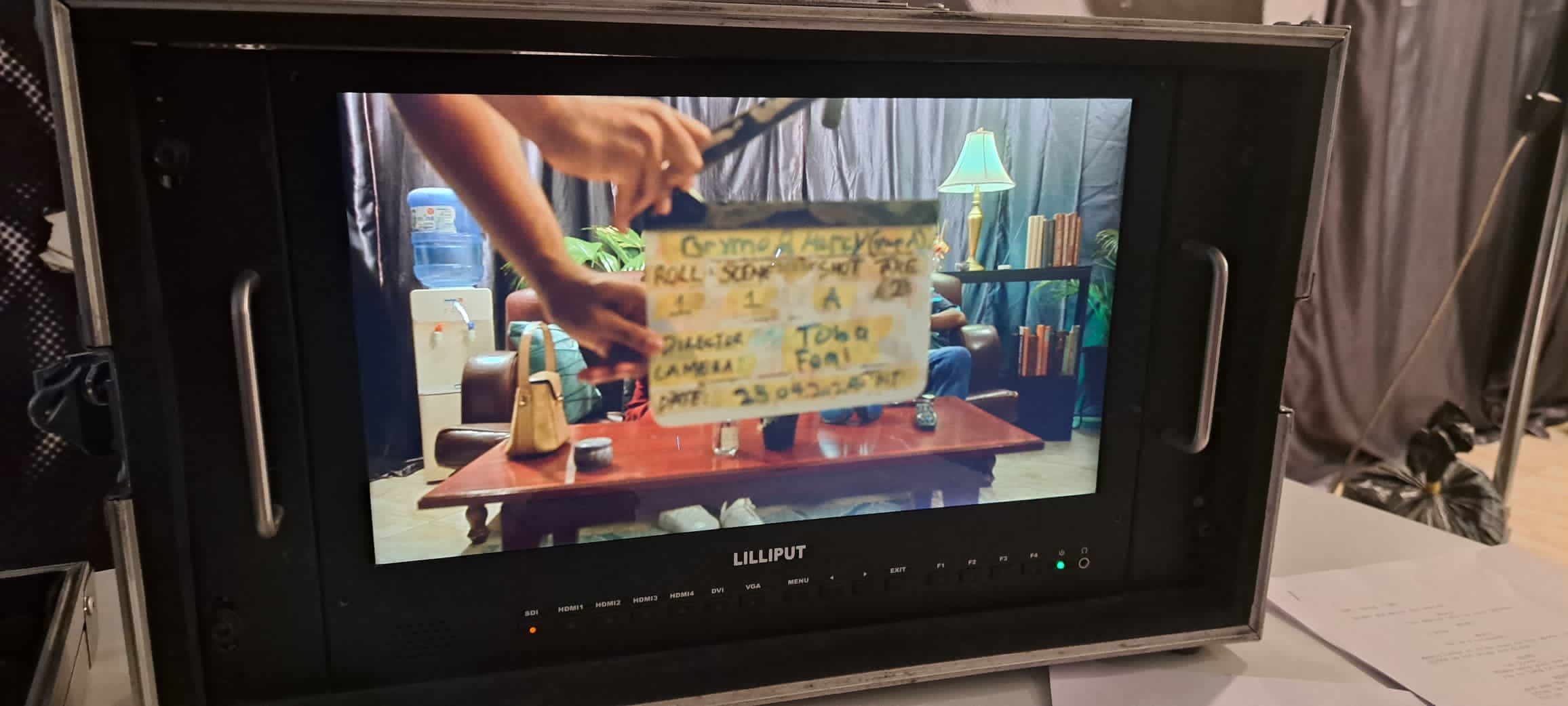 Field monitor showing a clapperboard slate for a take